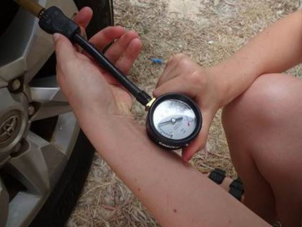 Off-road tire pressure check at Red Dirt Rentals, Queensland.